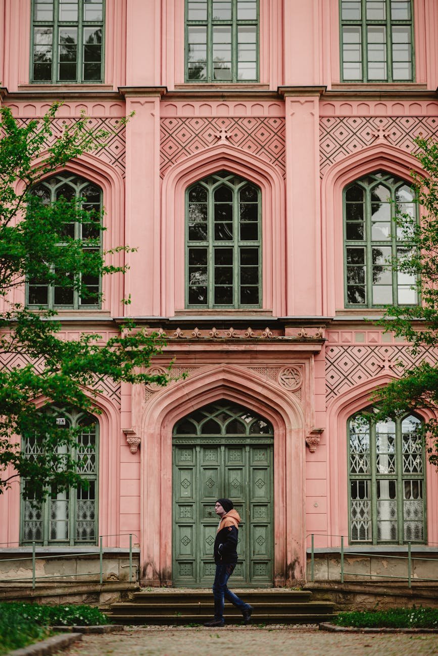 pink facade with arched door and windows
