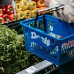 crop person purchasing assorted vegetables in grocery market